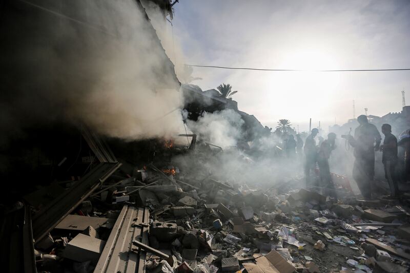 A photo of people searching through rubble in Gaza 