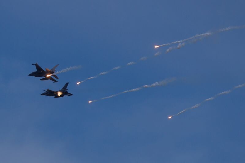 A photo of two F-16 fighter jets flying during a drill rehearsal over New Taipei City, Taiwan.