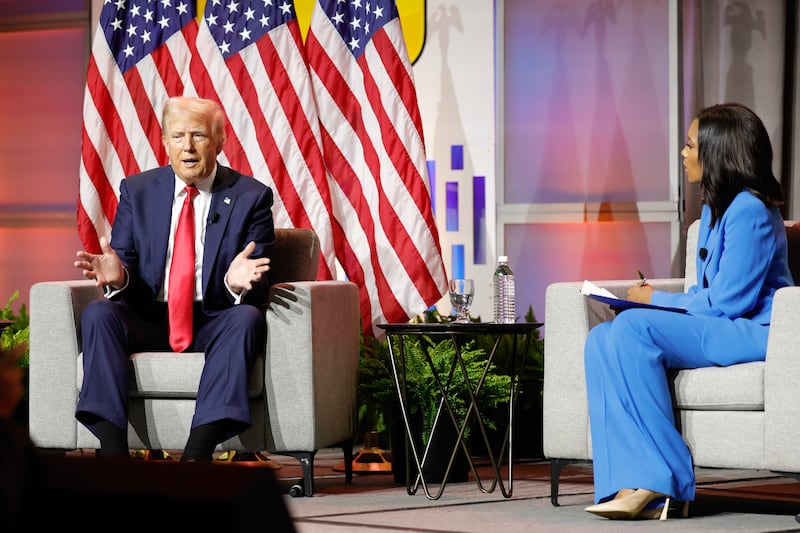 Trump, left, and Rachel Scott at the National Black Journalists Association convention.