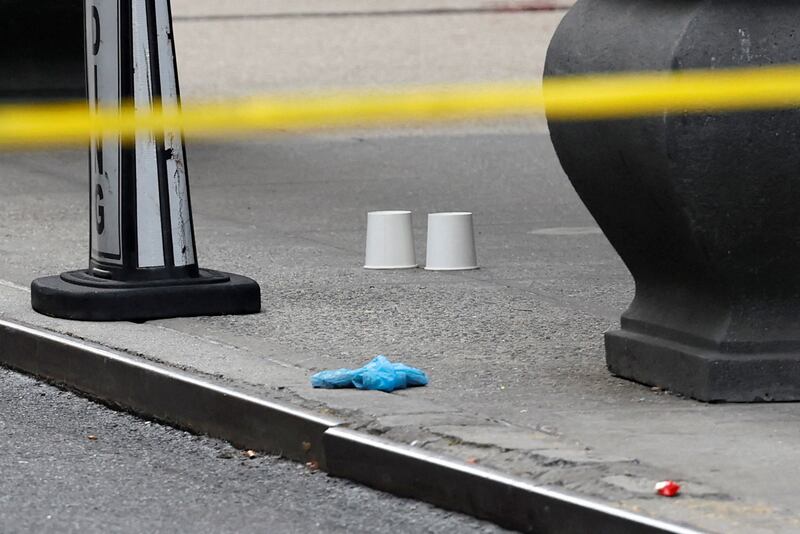 Cups mark the location of bullet casings found at the crime scene where United Healthcare CEO Brian Thompson was reportedly shot and killed on December 4, 2024 in Midtown Manhattan in New York City, USA