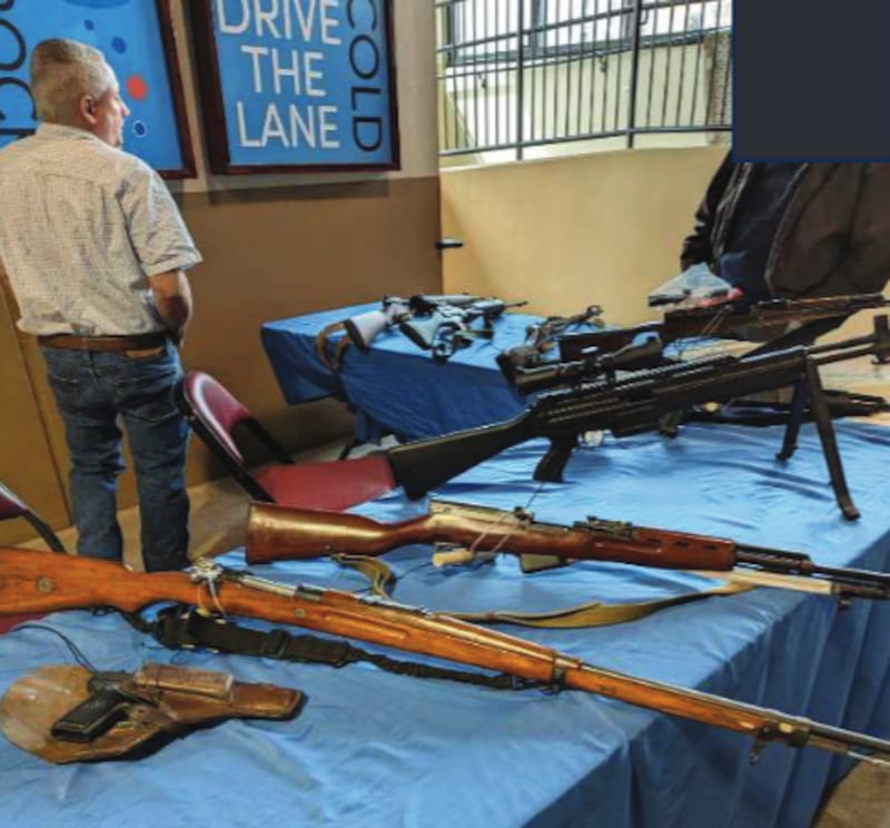 Prieto stands around his booth, where the FBI alleged he had nine guns strewn about.