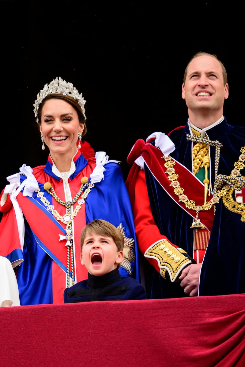 Catherine, Princess of Wales and Prince William, Prince of Wales and Prince Louis stand on the balcony of Buckingham Palace during the Coronation of King Charles III and Queen Camilla on May 06, 2023 in London, England.