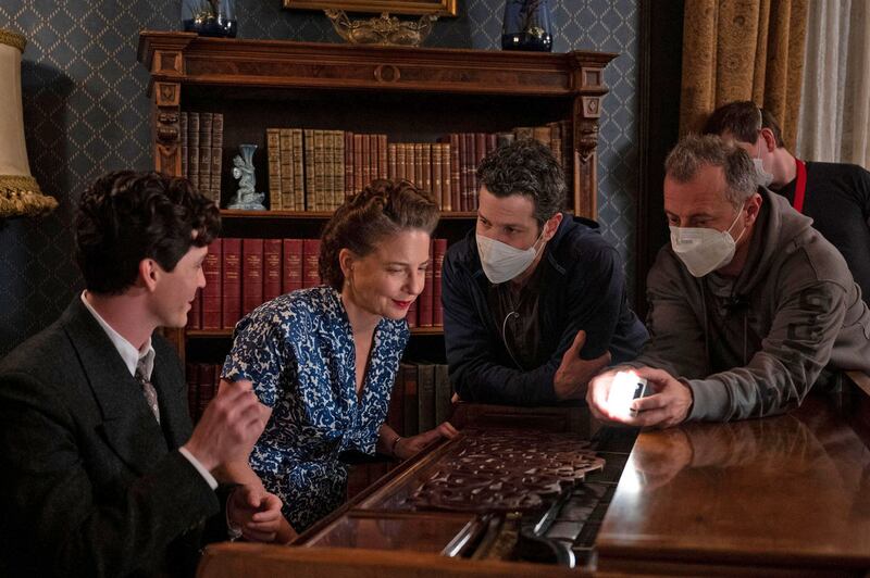 A behind the scenes photo of director Thomas Kail talking to actors Logan Lerman and Robin Weigert from ‘We Were the Lucky Ones’