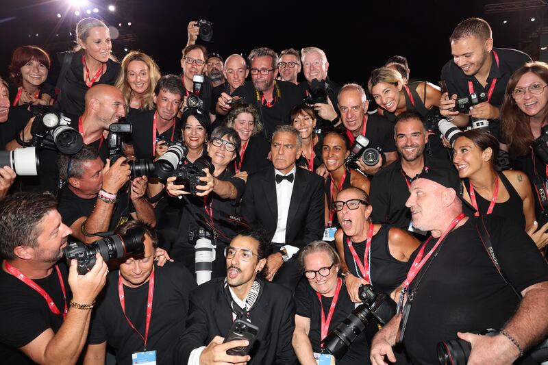 George Clooney poses with photographers on the red carpet during the Venice International Film Festival on September 1, 2024.