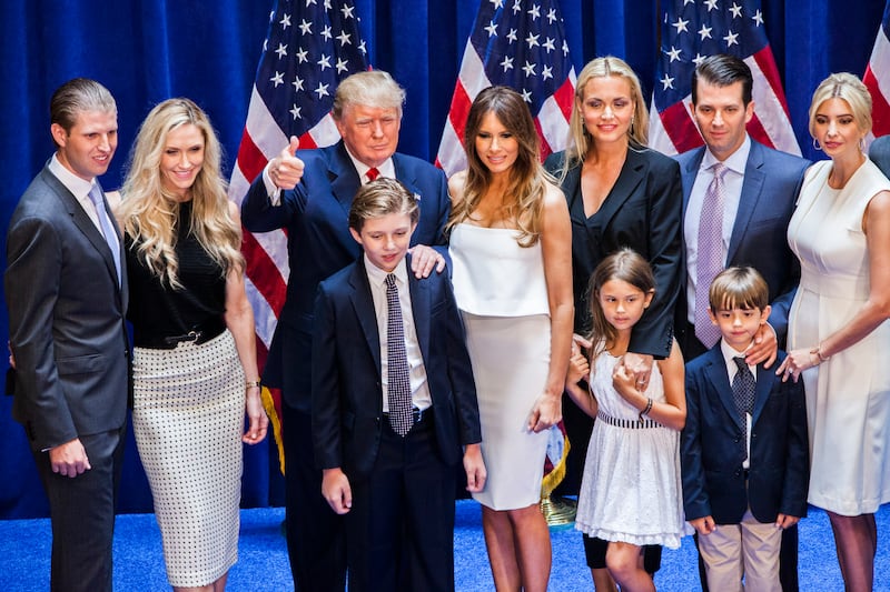 Trump making a thumbs up sign surrounded by Eric, Lara, Barron, Melania, Vanessa, Kai, Don Jr., Ivanka