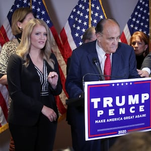 Jenna Ellis speaks as Boris Epshteyn reaches out to Rudy Giuliani during a news conference about the 2020 presidential election results at Republican National Committee headquarters in Washington, D.C., Nov. 19, 2020.