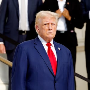 Republican presidential nominee, former U.S. President Donald Trump looks on during a wreath laying ceremony at the Tomb of the Unknown Soldier at Arlington National Cemetery on August 26, 2024