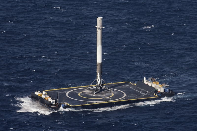 SpaceX boosters land on barges marked with circular targets.