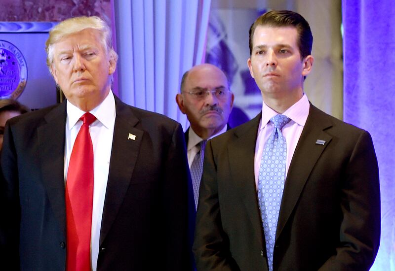 Donald Trump and his son Donald, Jr., with Allen Weisselberg (C)