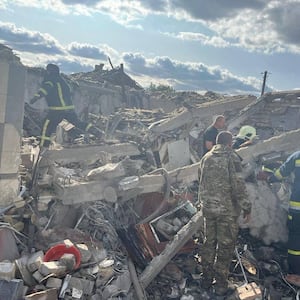 Rescuers work at a site of a Russian military strike, amid Russia's attack on Ukraine, in the village of Hroza, in Kharkiv region,