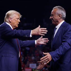 Donald Trump is greeted by Robert F. Kennedy Jr.