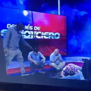 Workers lie on the floor as armed men take over a tv studio in Ecuador. 