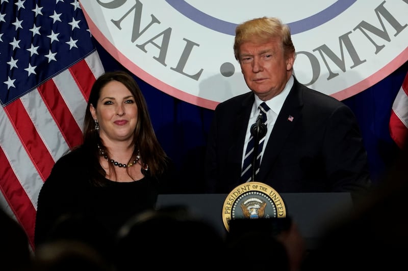 Donald Trump and Ronna McDaniel stand together behind a podium.