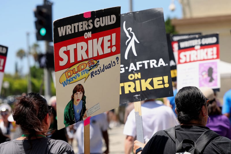 Writers Guild of America protesters march with signs in Los Angeles.