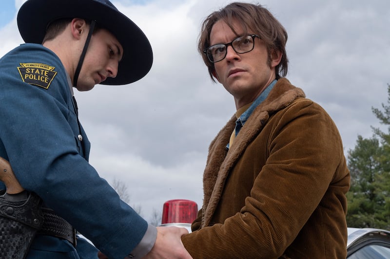 Jonathan Bailey has his hands handcuffed by an officer in a still from ‘Fellow Travelers’