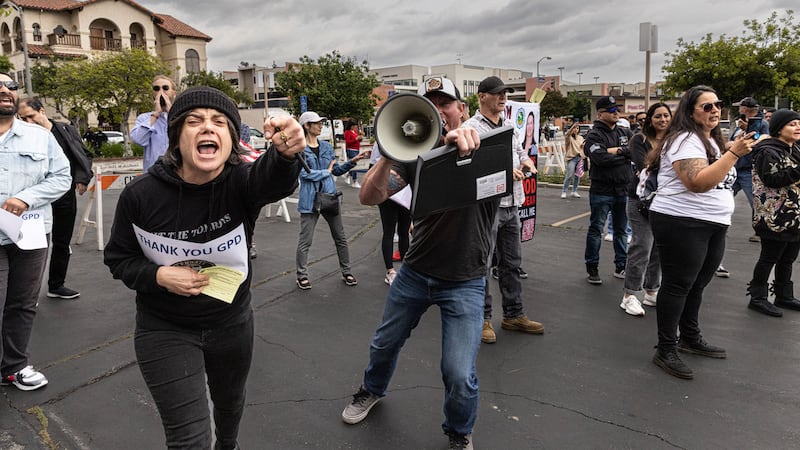 Bryce Henson (with the bullhorn) has become a leading figure at school board protests in California. 