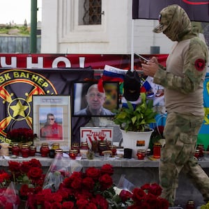 An alleged member of the Wagner private military group stands guard at the informal memorial for the Wagner leader Yevgeny Prigozhin near Red Square in Moscow. 