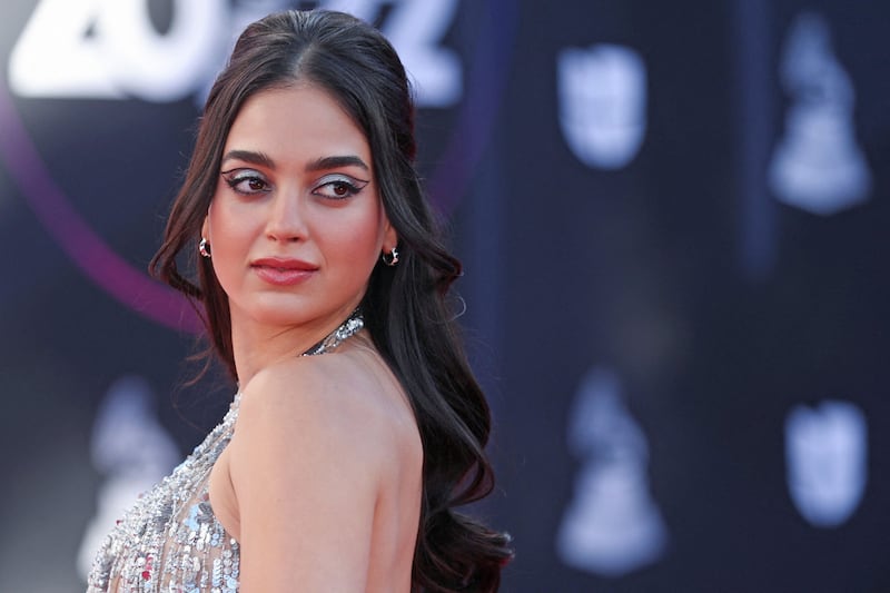 Melissa Barrera poses on a red carpet.