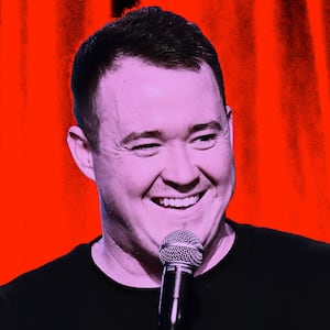 Photo illustration of Shane Gillis performing standup with a red background.