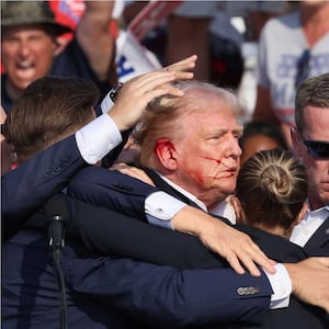 Secret Service agents dog-pile on Donald Trump (left) after the sound of gunshots break out at his rally and security (right) moves into new positions.